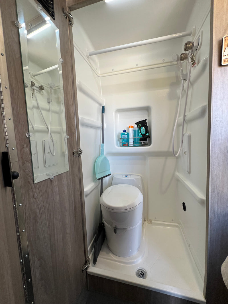Compact RV rental bathroom with integrated shower, toilet, and toiletries. Practical wet bath design for travel. — photo 6
