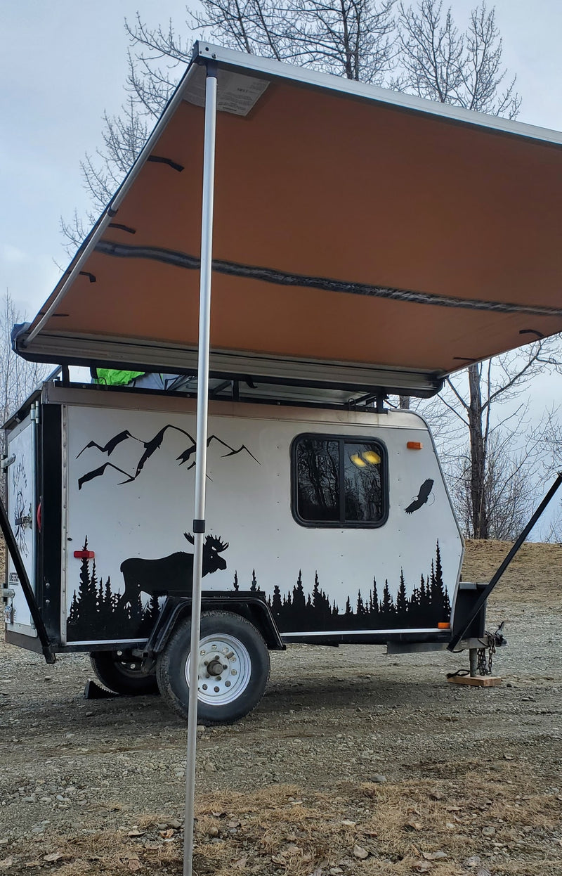 Customized small camper trailer with an extended awning, featuring nature decals of moose, trees, and birds. Ideal for an RV rental or camping trip. — photo 14