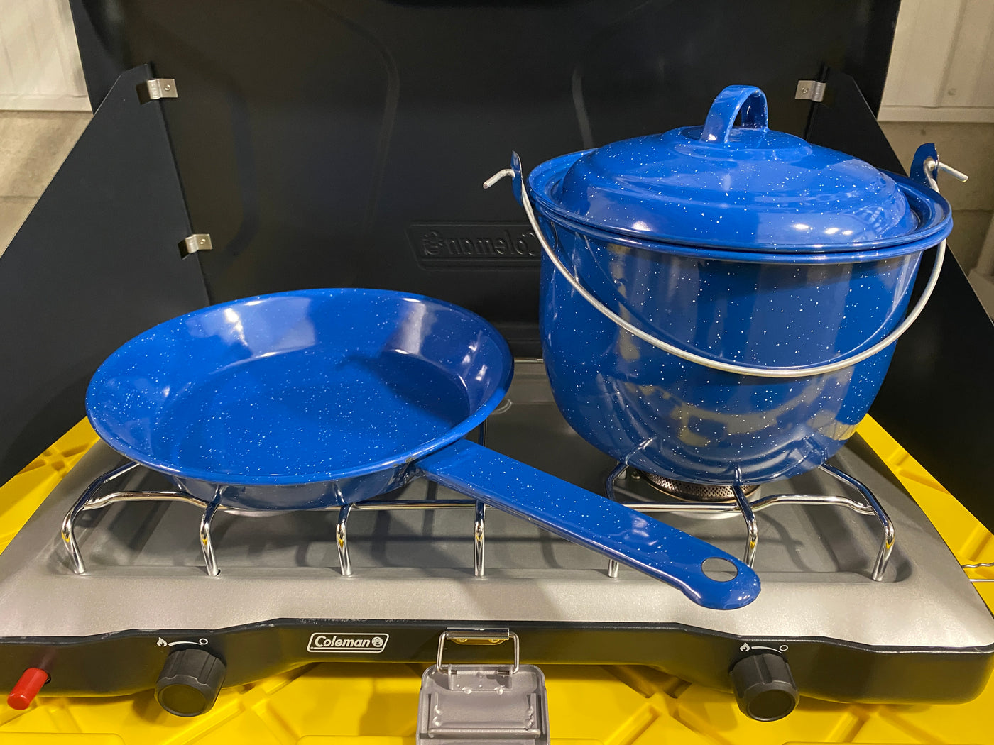 Blue speckled camping pot and pan on a Coleman portable stove, ideal for outdoor cooking on your next RV rental adventure. — photo 17
