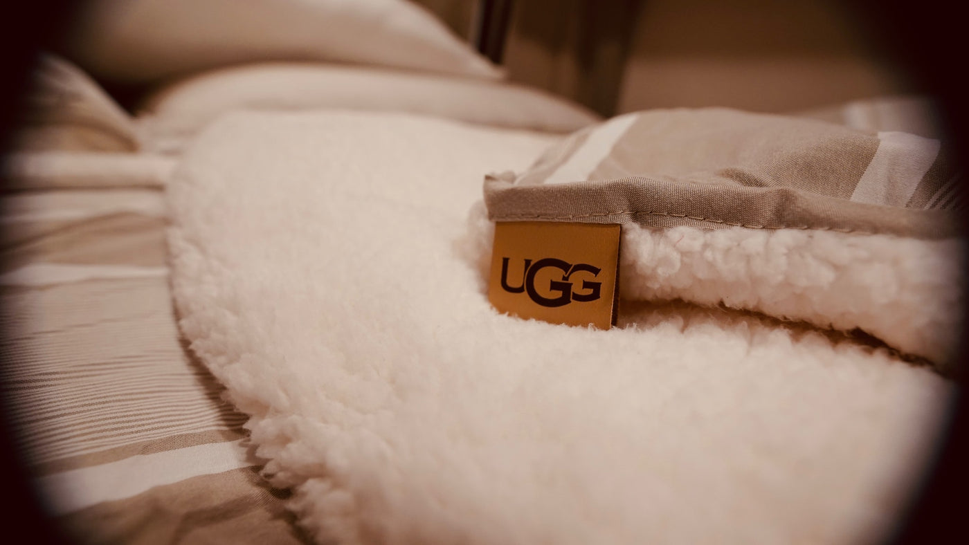 Close-up of a fluffy UGG blanket with its tag, offering cozy comfort for your RV rental adventure. — photo 4