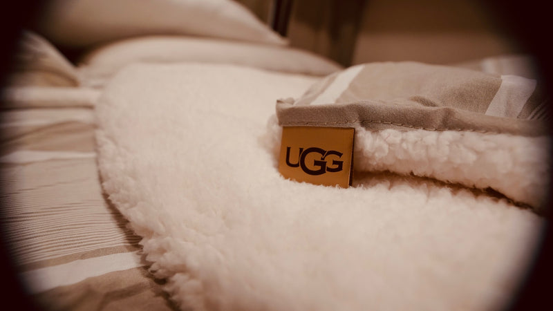 Close-up of a fluffy UGG blanket with its tag, offering cozy comfort for your RV rental adventure. — photo 4