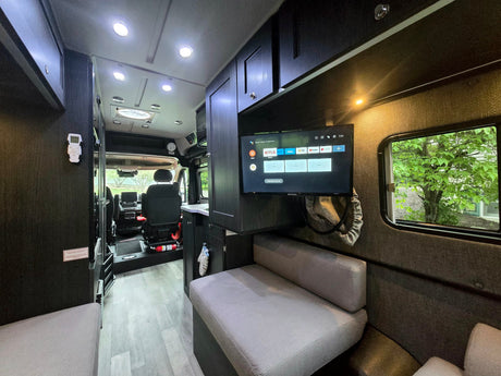  and bright view to the driver's cabin.|A black Roadtrek Play RV