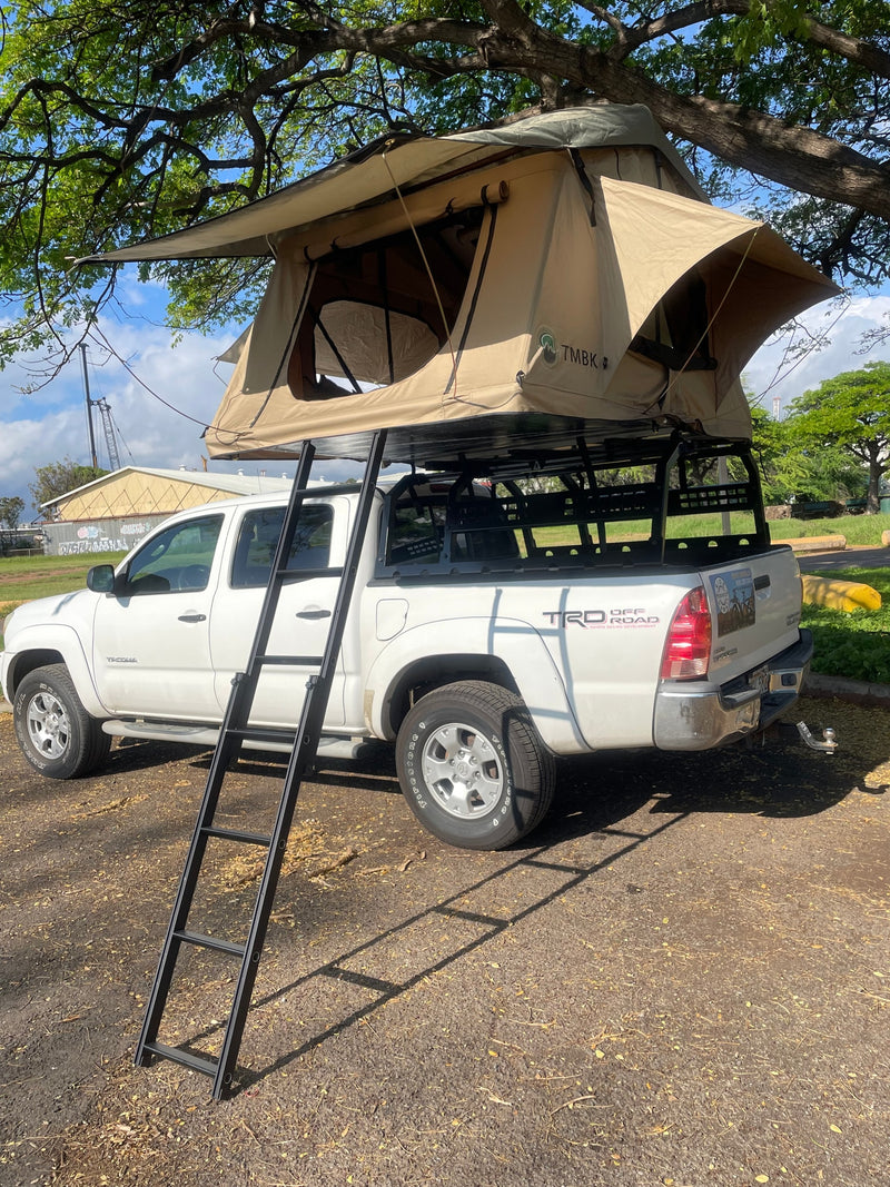An `RV rental` white Toyota Tacoma with a tan rooftop tent and ladder, ready for truck camping adventures. — photo 12