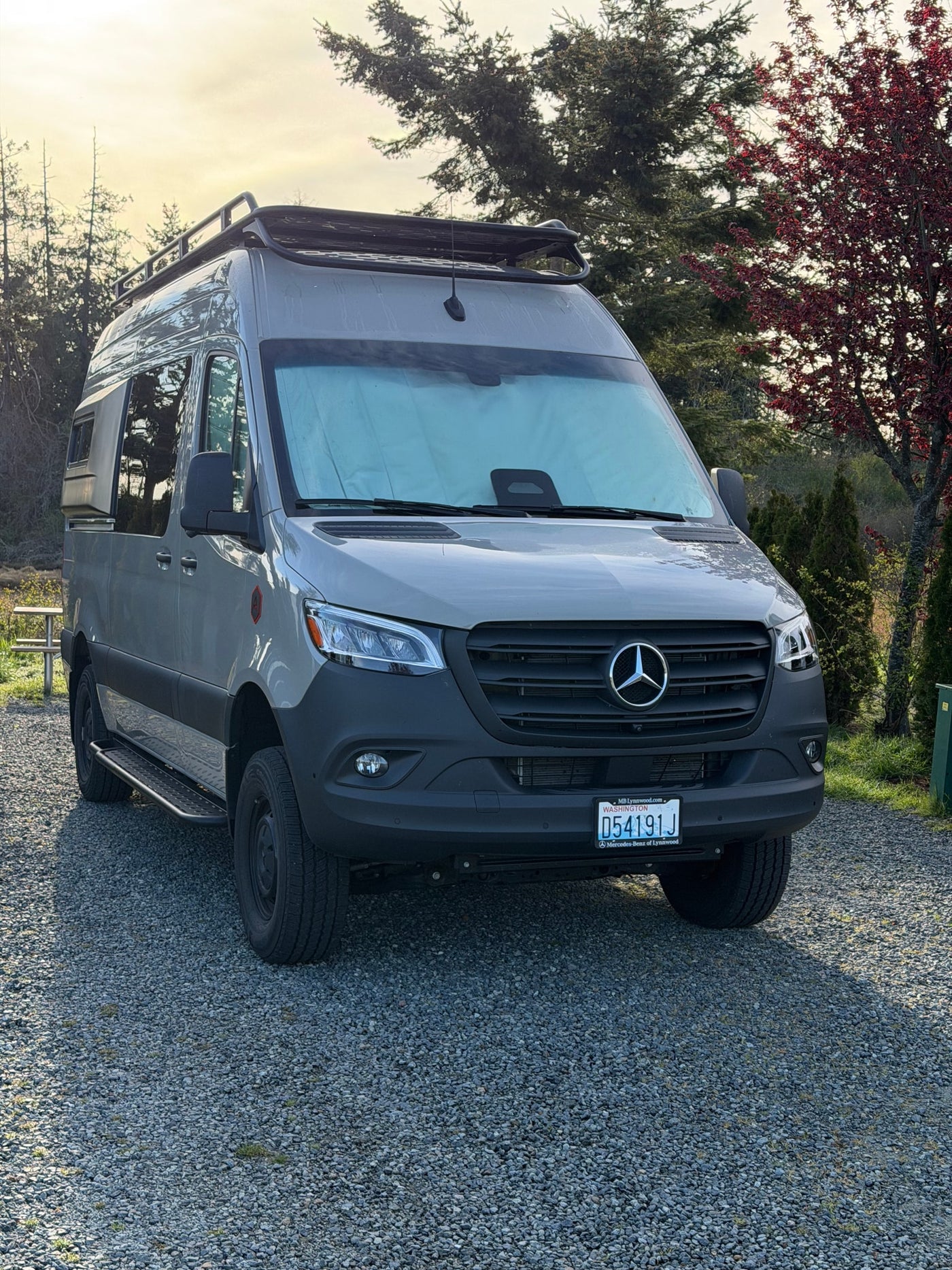 Gray Mercedes-Benz Sprinter camper van, ideal for rv rental, parked on gravel surrounded by trees. — photo 10