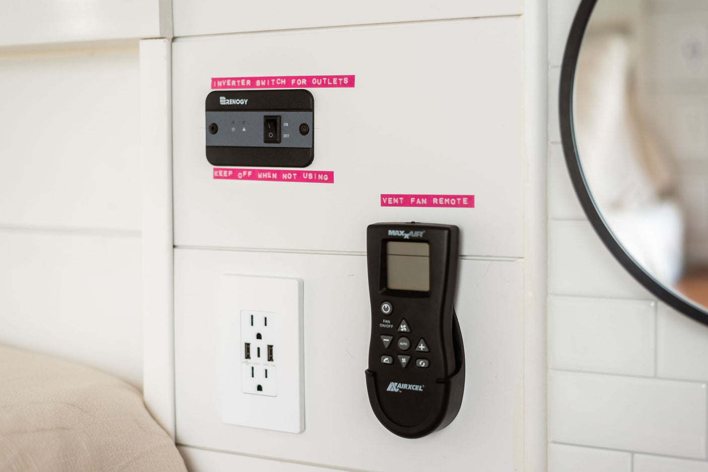 RV rental features: Renogy inverter for outlets, USB outlet, and MaxxAir vent fan remote on a white interior panel.