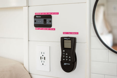 RV rental features: Renogy inverter for outlets, USB outlet, and MaxxAir vent fan remote on a white interior panel.