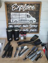 RV rental kitchen essentials: utensils, mugs, spices, and an "Explore" sign, ready for your adventures.