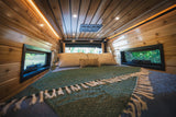Inside a comfortable RV rental bedroom, featuring warm wood walls, ceiling lights, and scenic windows.