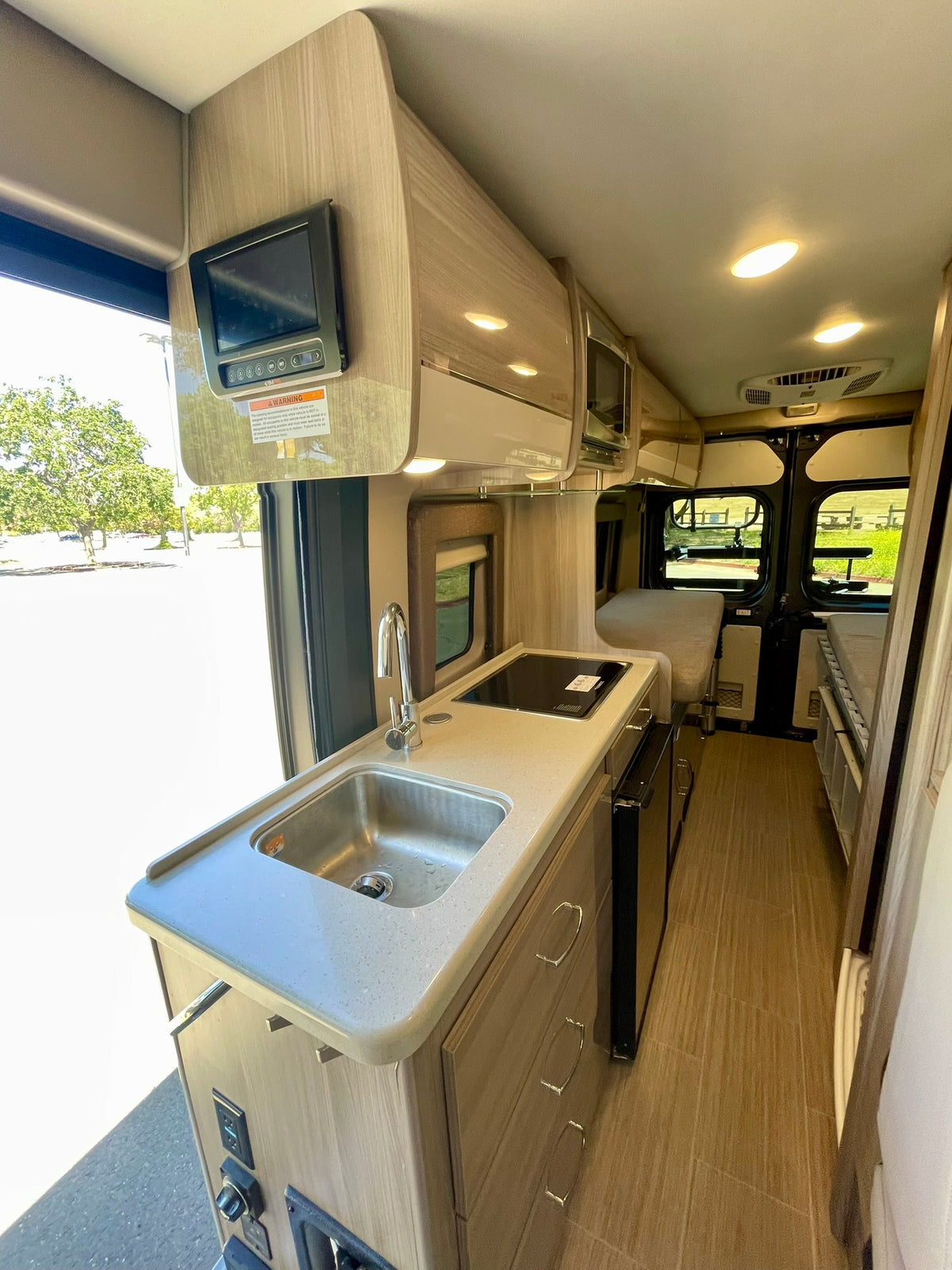  and cozy living space.|Modern RV rental interior: kitchen — photo 15