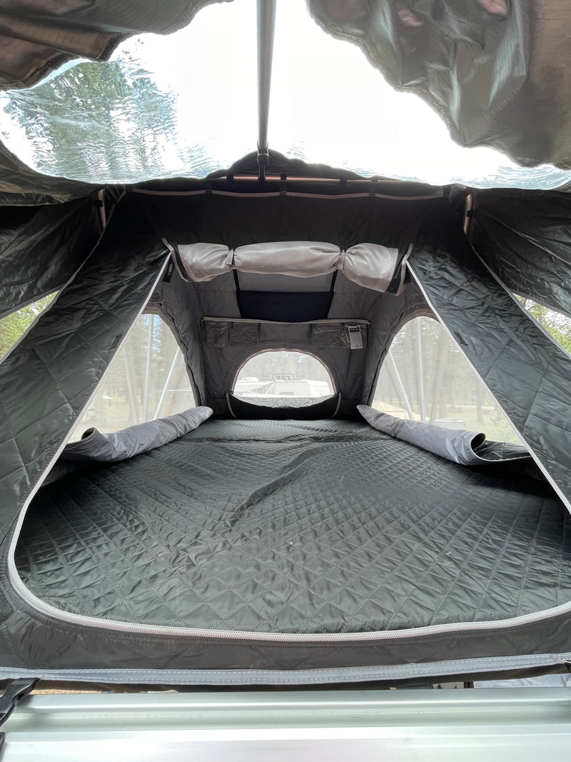 Interior of a comfortable rooftop tent, perfect for an RV rental adventure. Features quilted mattress, mesh windows & storage. — photo 11