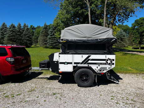 Patriot X3 trailer hooked up and ready to tow, tent up, three-quarter rear view