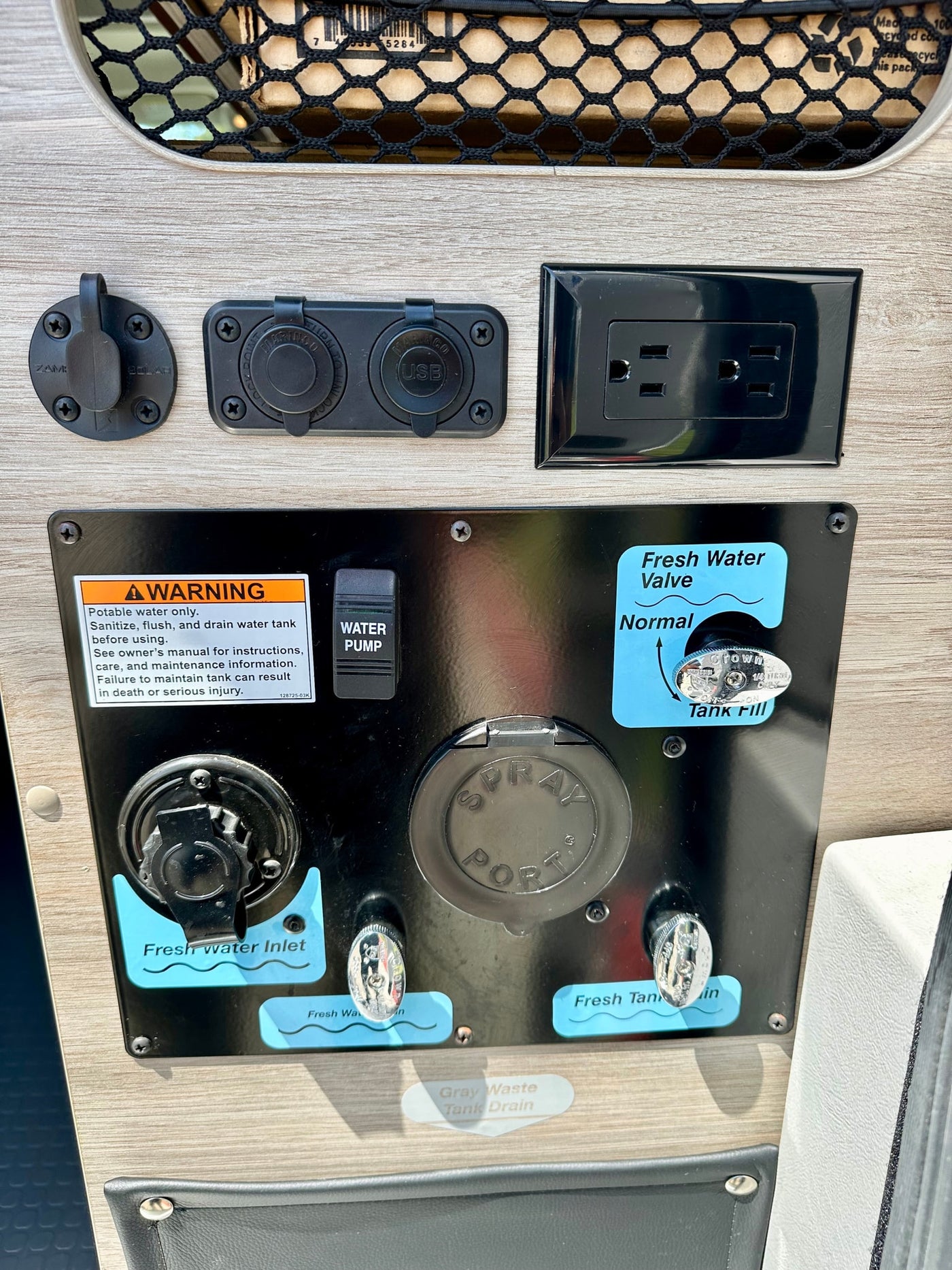 RV rental control panel: water system (inlet, pump, valves, drains) and power (solar, USB, AC) connections. — photo 17