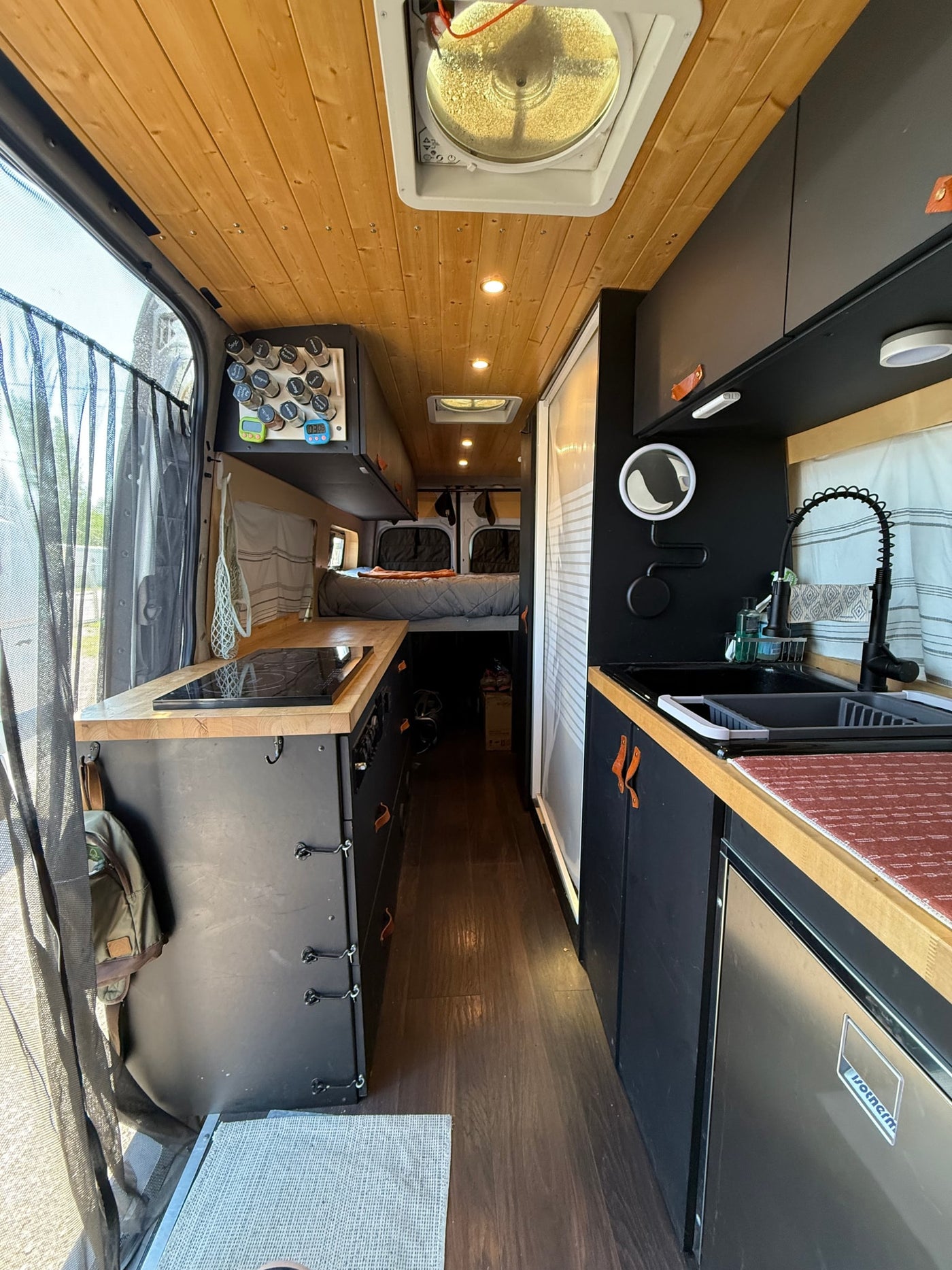  showcasing distant mountains under a blue sky.|RV rental van cabin: front seats — photo 6