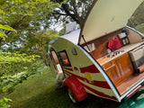 This teardrop RV rental's open galley kitchen invites outdoor cooking & camping adventures in nature.