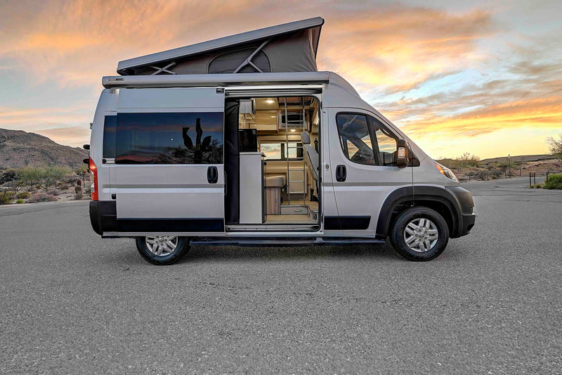 Silver pop-top camper van for your next RV rental adventure. Interior visible — photo 1