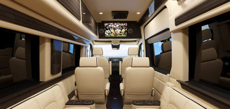 Luxurious RV rental interior, featuring plush seating, wood accents, and a large TV, perfect for comfortable group travel.