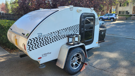 This white LittleGuy teardrop RV rental, a Rough Rider, is ready for your next camping adventure.