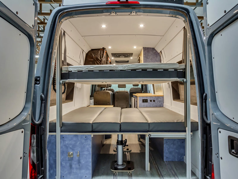  and ample storage.|Spacious RV rental van conversion interior with diner-style seating — photo 6