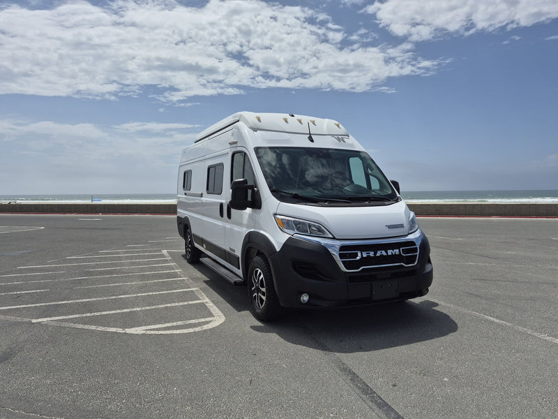  ideal for beach adventures.|White Winnebago Solis RV rental parked by the ocean on a sunny day — photo 11