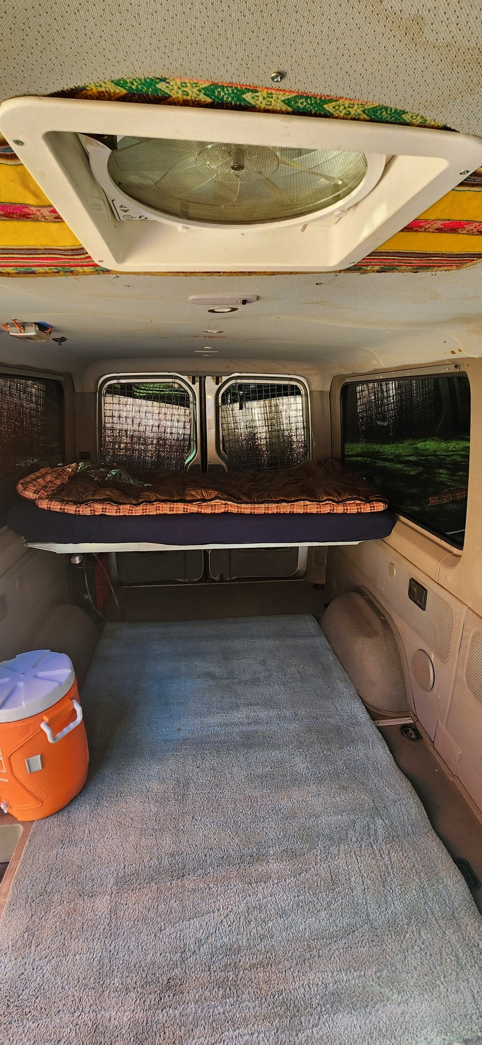  & orange canopy for shaded outdoor camping.|Explore this RV rental van's cozy interior: elevated bed — photo 3