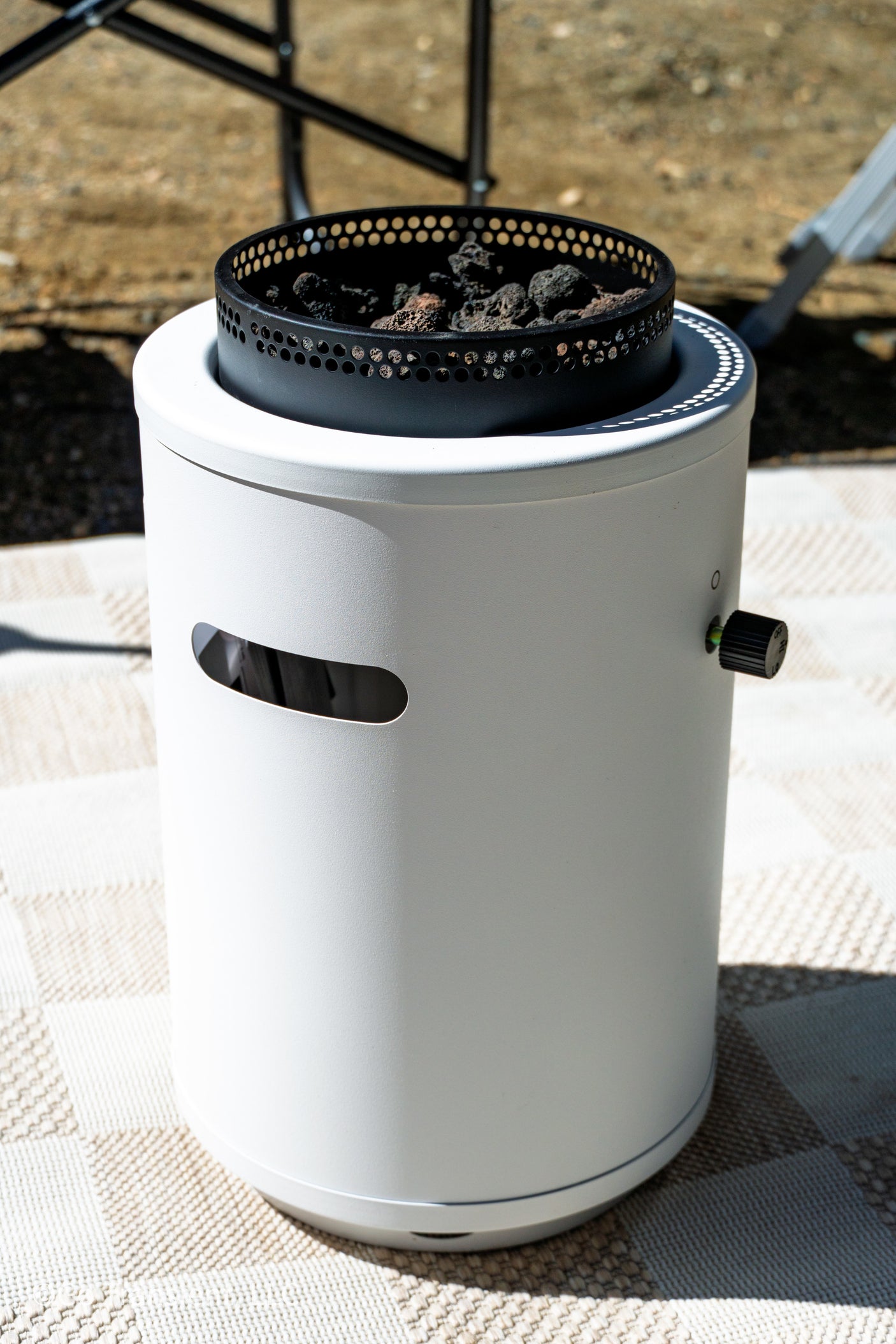 Cozy up your RV rental experience with this portable outdoor fire pit, featuring lava rocks and a gas control knob.