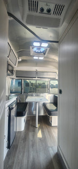 Modern Airstream RV rental interior with kitchen, dining, and stylish design. Perfect for travel adventures.