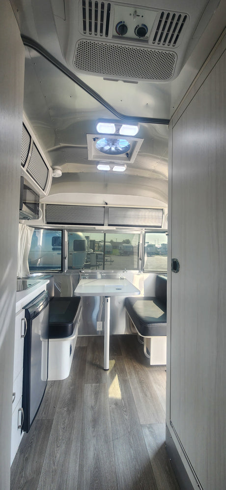 Modern Airstream RV rental interior with kitchen, dining, and stylish design. Perfect for travel adventures.