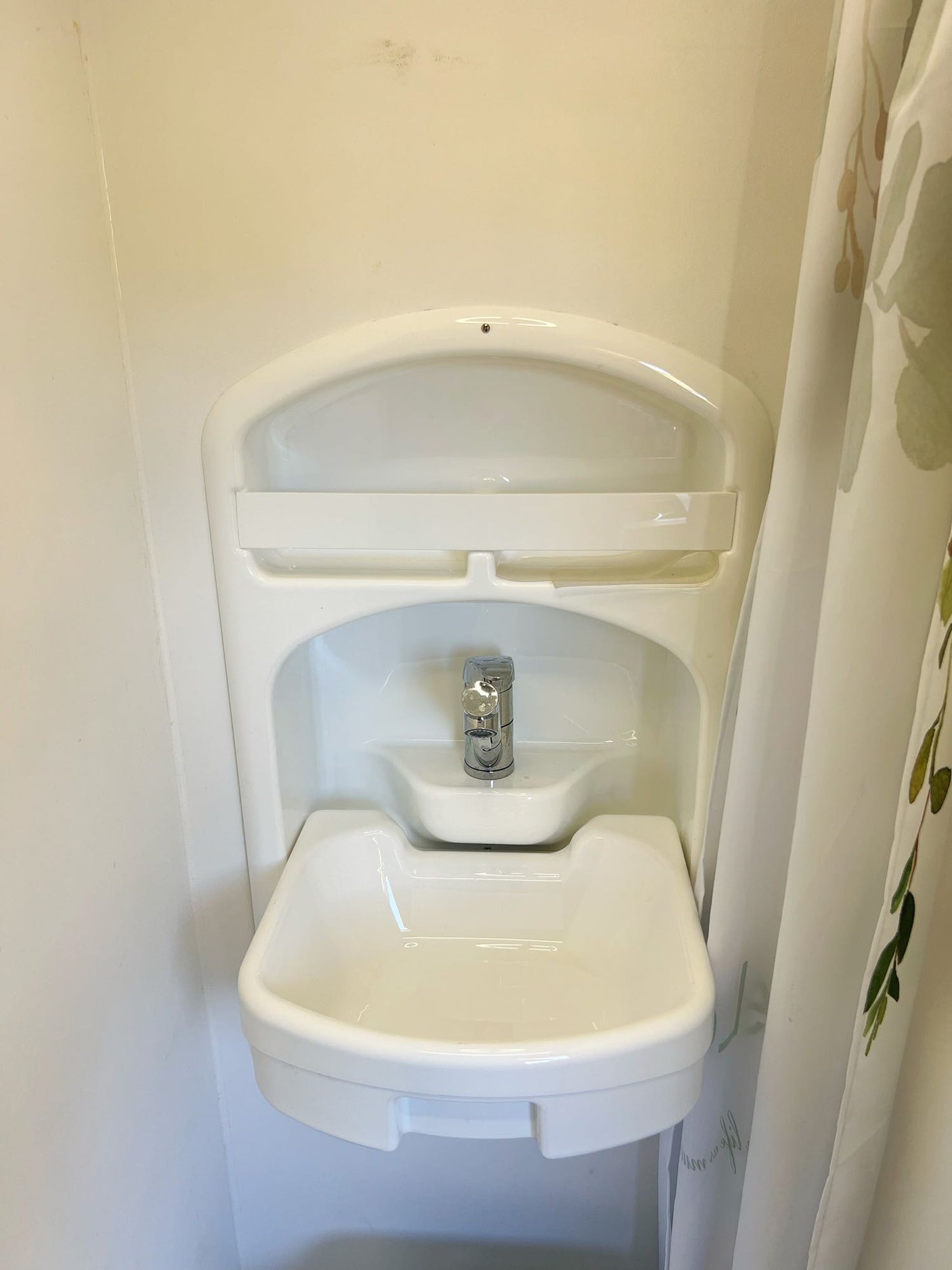 Compact bathroom sink and faucet, a key amenity in this RV rental.