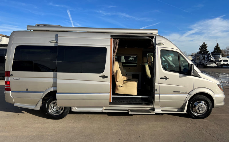 This spacious Mercedes-Benz Sprinter rv rental features an open side door, revealing its light-colored luxury interior. — photo 5