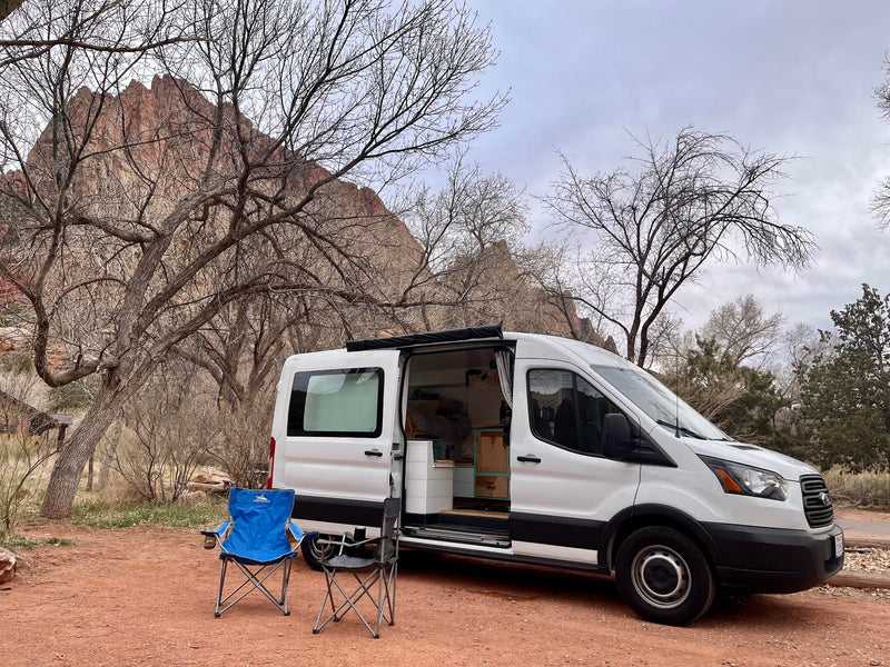  and clever storage solutions for your adventure.|Experience cozy RV rental living! This camper van features a comfy bed — photo 1