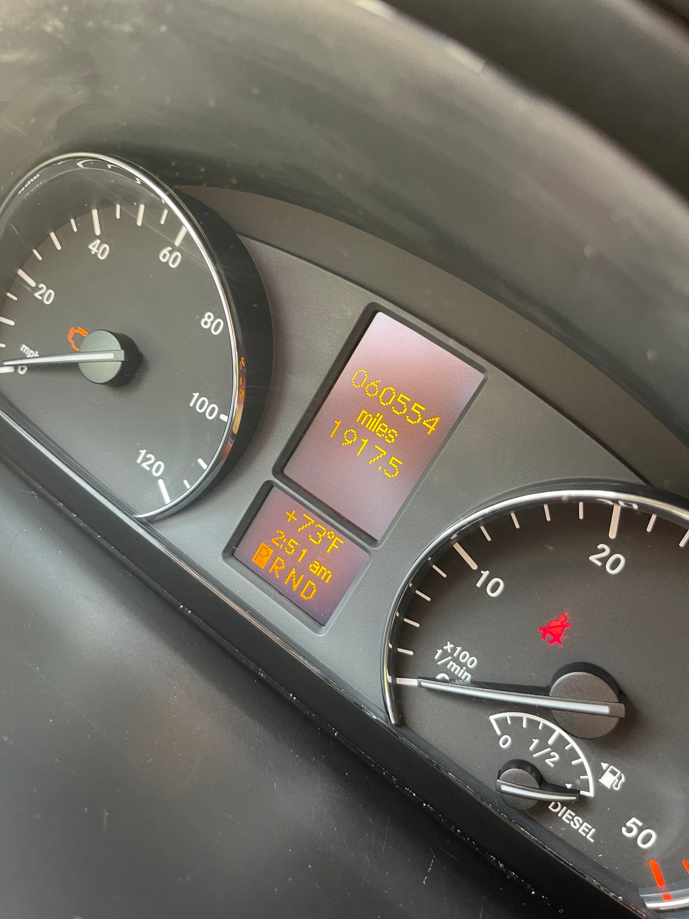 RV rental dashboard: 60,554 miles, 73°F, 2:51 AM. Diesel is near full, speedometer at 10 mph, seatbelt light on.