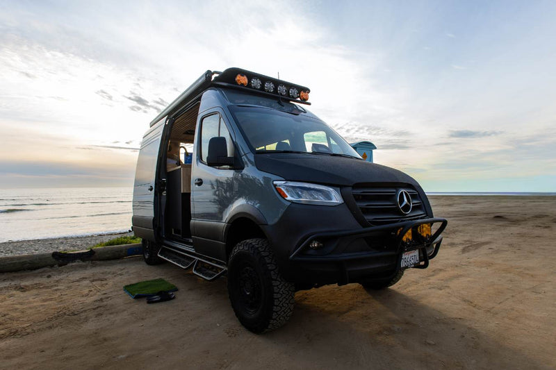  set in a wood-paneled camper van.|Inside a modern RV rental: Mercedes Sprinter cockpit with a large infotainment screen — photo 4