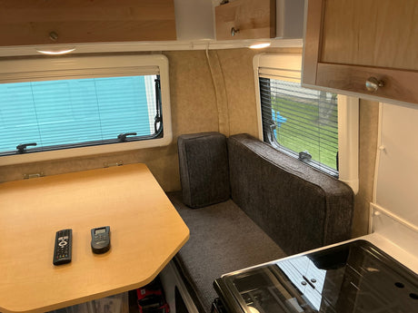  stabilized in a driveway. Perfect RV rental for your next road trip or outdoor adventure!|White RV rental with its main door open