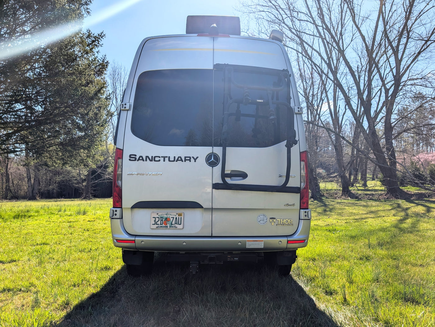  a sleek camper van with bike rack and roof awning — photo 10