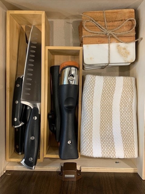 RV rental kitchen drawer with organized knives, wine opener, coasters, and towel. Compact storage for cooking essentials. — photo 15