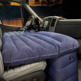 RV rental front seat air mattress for car camping: comfy sleeping setup in a van, with a twilight lake view outside.