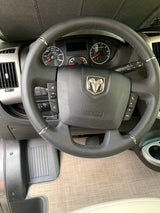 Driver's view in an RV rental, showing the Ram steering wheel, dashboard, and vehicle interior.
