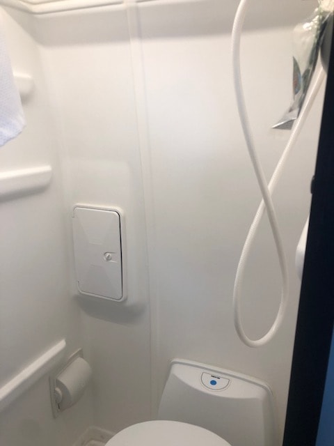  and patterned seat with seatbelt offer compact comfort.|Interior of a sleek rv rental — photo 9