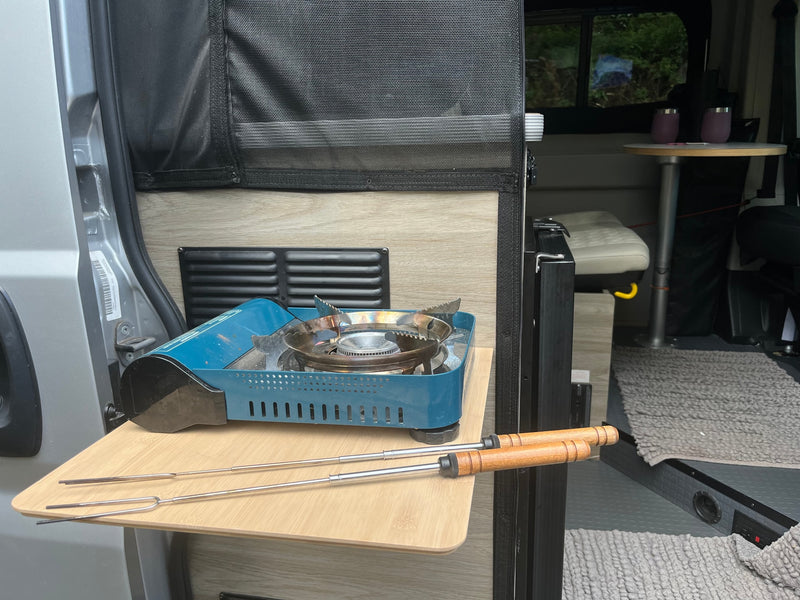 An RV rental's clever pull-out kitchen with a portable gas stove and roasting sticks, ready for camp meals. — photo 6