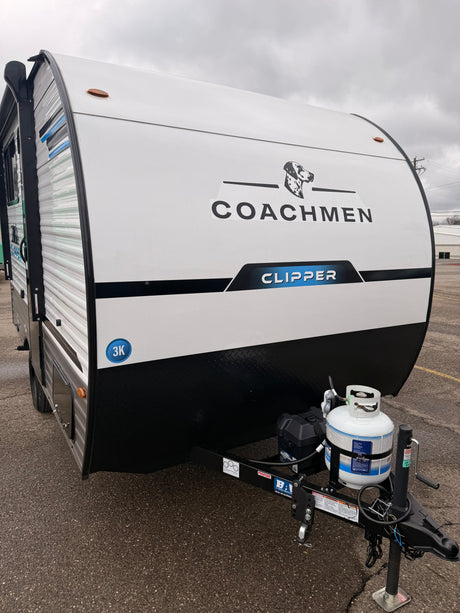 Front of a white Coachmen Clipper travel trailer, equipped with a propane tank, ready for an rv rental camping adventure.