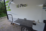 Flagstaff E-Pro RV rental side view, featuring an exterior table. Great for outdoor cooking & camping adventures.