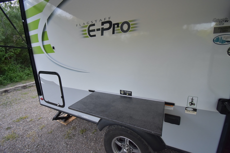 Flagstaff E-Pro RV rental side view, featuring an exterior table. Great for outdoor cooking & camping adventures.
