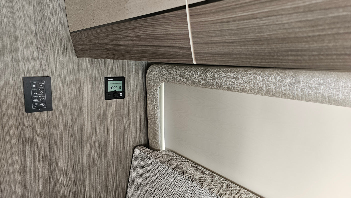 RV rental interior featuring control panels for lighting, awning, and climate, essential for comfort on the road.