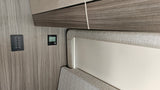 RV rental interior featuring control panels for lighting, awning, and climate, essential for comfort on the road.