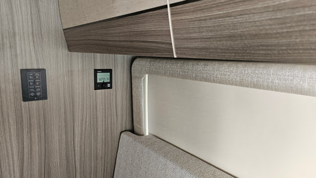 RV rental interior featuring control panels for lighting, awning, and climate, essential for comfort on the road.