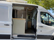  a converted camper van with roof solar panels and AC