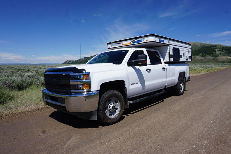 majestic snow-capped mountains.|White pickup truck with a Four Wheel Pop-Up Camper RV rental — photo 9