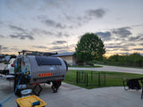 RV rental: A Modern Buggy teardrop trailer with solar panels is set up at a campsite with a pet pen.
