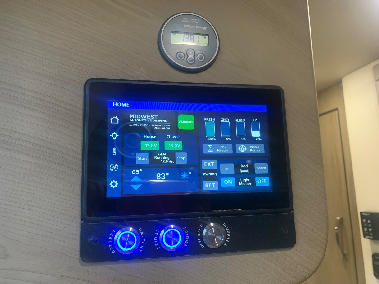 This RV rental's sophisticated control panel in a camper van displays battery, tank levels, generator status, and other system controls.