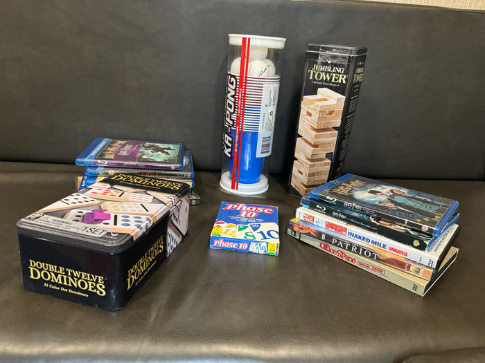 Games & movies perfect for an RV rental: Double Twelve Dominoes, Phase 10, Ka-Pong, Jumbling Tower, & Blu-rays/DVDs.